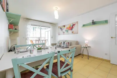 a kitchen and living room with a table and chairs at Nice 1 Bedroom downtown Carré d'Or with garage in Nice