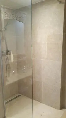 a shower with a glass door in a bathroom at La maison de lulu in Nice