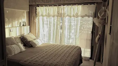 a bedroom with a bed in front of a window at La maison de lulu in Nice