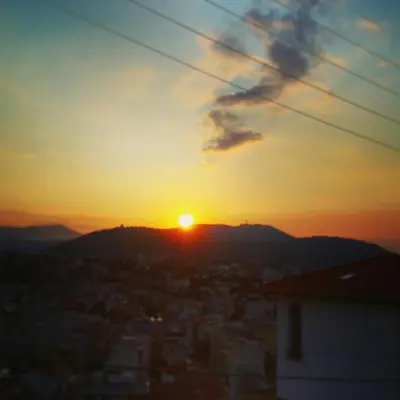 a view of the sun setting over a city at La maison de lulu in Nice