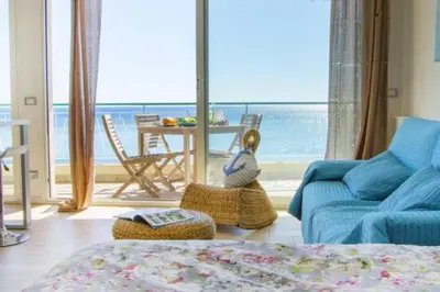 a living room with a blue couch and a view of the ocean at MY CASA - PROM 13 - Sea View - Promenade des Anglais - Terrace in Nice