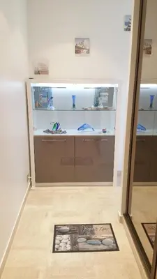 a large display case in a room with a mirror at Roc et Galets in Saint-Laurent-du-Var