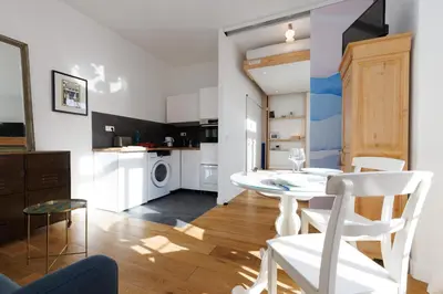 a kitchen and dining room with a white table and chairs at 1 Bdr Downtown near Place Massena in Nice