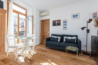 a living room with a couch and a table at 1 Bdr Downtown near Place Massena in Nice