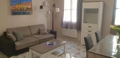 a living room with a couch and a table at Au Coeur du vieux Nice in Nice