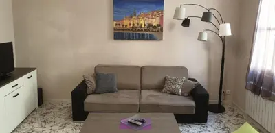 a living room with a couch and a lamp at Au Coeur du vieux Nice in Nice
