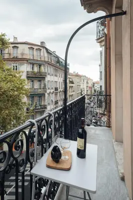 a bottle of wine sitting on a table on a balcony at Nice Appartement Rue D'Italie in Nice
