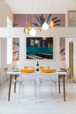 a dining room with a white table and chairs at Palais Saleya Boutique Hôtel in Nice