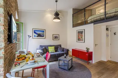 a living room with a couch and a table at MY CASA - 4 PLACE MASSENA - DUPLEX in Nice