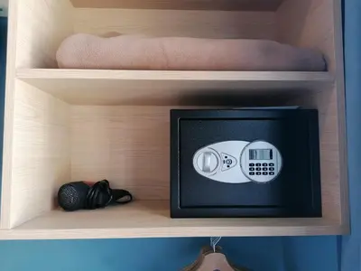 a cabinet with a microwave on a shelf at Hôtel Du Centre, un hôtel AMMI in Nice