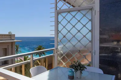a balcony with a table and a view of the ocean at ROYAL PROMENADE Pool Terrace Sea View Air Conditioning in Nice