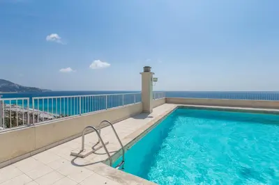a staircase in a building with escalators in a lobby at ROYAL PROMENADE Pool Terrace Sea View Air Conditioning in Nice