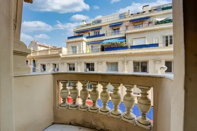 a balcony with a building in the background at L'Écrin Blanc Niçois - Welkeys in Nice