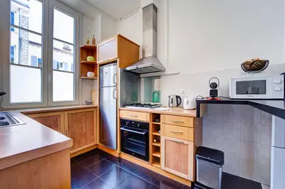 a kitchen with a stove top oven next to a window at L'Écrin Blanc Niçois - Welkeys in Nice