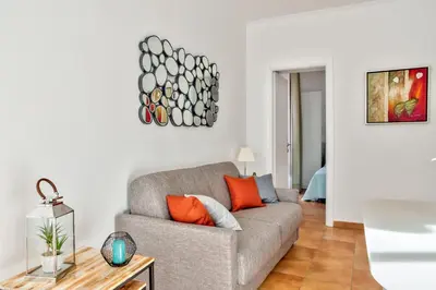 a living room with a couch and a table at L'Olivette in Nice
