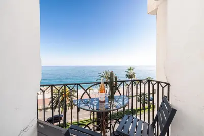 a balcony with a table and chairs and the ocean at Sea view - 2 Bdr Promenade des Anglais in Nice