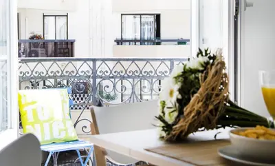 a table with a bowl of food and flowers on a balcony at MY CASA - 48 GIOFFREDO - NEAR PLACE MASSENA in Nice