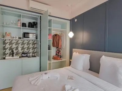 a bedroom with a white bed and a closet at Hotel Aparthotel AMMI Nice Lafayette in Nice