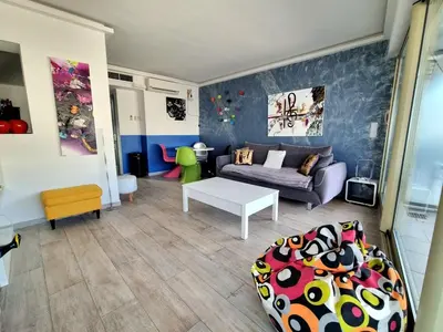 a living room with a couch and a table at Royal Lux NICE -Last floor, see view in Nice