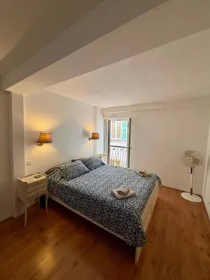 a bedroom with a bed and a window at Rue Neuve - Old Town Apartment in Nice