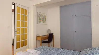 a bedroom with a bed and a desk at Rue Neuve - Old Town Apartment in Nice