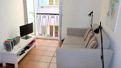 a living room with a couch and a tv at Rue Neuve - Old Town Apartment in Nice