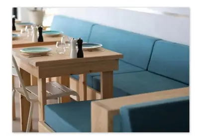 a table with two chairs and a blue couch at Hôtel Le Versailles in Villefranche-sur-Mer
