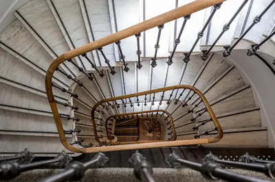 a spiral staircase in an old building at Hotel Select in Beaulieu-sur-Mer