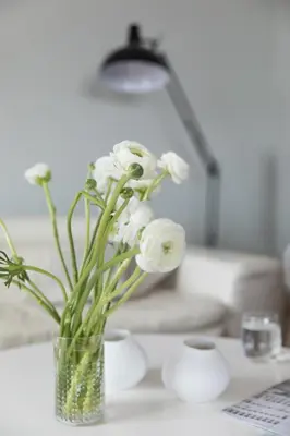 a vase filled with white flowers on a table at Stunning seaview villa. Villefranche Sur Mer in Villefranche-sur-Mer