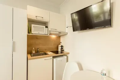 a small kitchen with a sink and a microwave at Nice Home - Studios Lido in Nice
