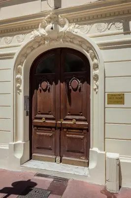 a large wooden door on the side of a building at Nice Home - Studios Lido in Nice