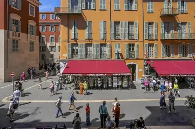 a group of people walking around a street with buildings at MY CASA - PAULE - Great Old Town Studio w AC in Nice