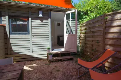 a backyard with two chairs and a shed at Camping Les Cent Chênes in Saint-Jeannet