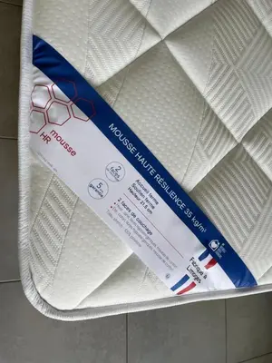 a package of white sheets on a bed at beau studio in Nice