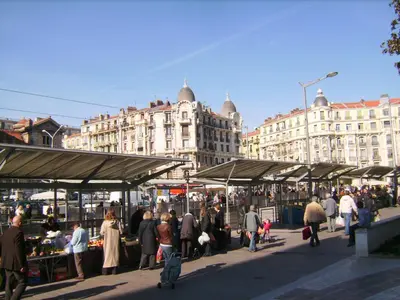 a group of people walking around a market in a city at Riviera Terrasse - parking gratuit in Nice