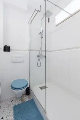 a bathroom with a toilet and a glass shower at Promenade des anglais Vue mer in Nice