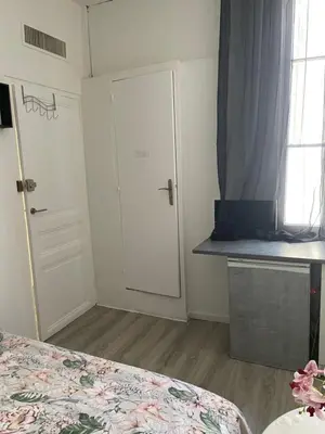 a bedroom with a bed and a door and a window at iNICE in Nice