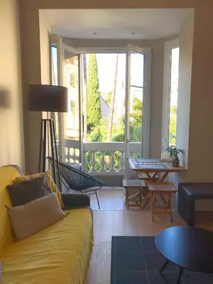 a living room with a couch and a large window at Dreamplace in Nice
