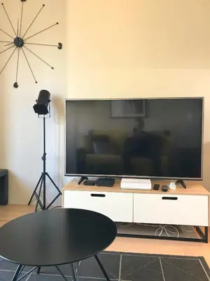 a living room with a large flat screen tv at Dreamplace in Nice