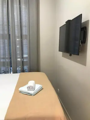 a bedroom with a bed with a tv on the wall at Dreamplace in Nice