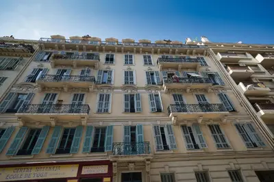 a tall building with balconies on a city street at Lusso 5 beds Central Apartment in Nice
