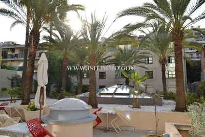 a patio with a table and chairs and palm trees at Superbe Studio in Nice at 450m from the sea with Clim in Nice
