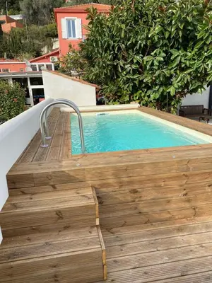 a small swimming pool on a balcony with a wooden deck at Hôtel La Villa Patricia - Charme et Tradition in Villefranche-sur-Mer