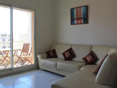 a living room with a couch and a balcony at Top Floor Apartment Santa Barbara in Nice