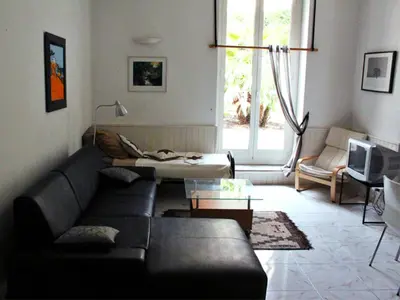 a living room with a couch and a table at Apartment Villa Anahit in Nice