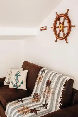 a brown couch with a nautical blanket on it at Adorable apartment in Nice downtown in Nice