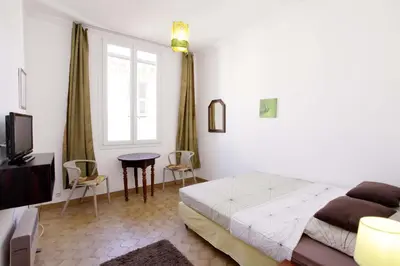 a bedroom with a bed and a tv and a table at Niceaparts in Nice