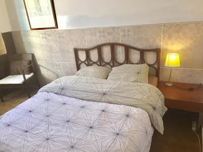 a bedroom with a large bed with white sheets and a desk at Niceaparts in Nice