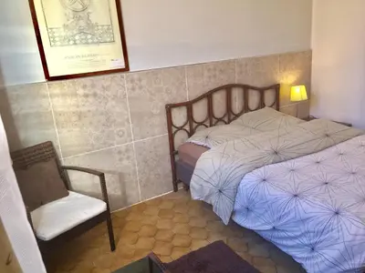a small bedroom with two beds and a chair at Niceaparts in Nice