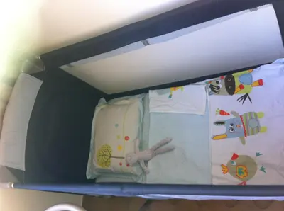 a shelf in a room with a crib with a toy at Niceaparts in Nice